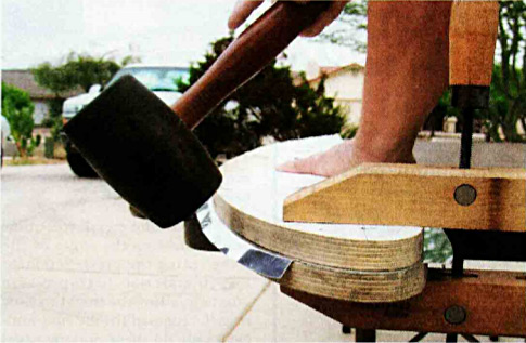 Using any of a variety of pounding tools you can bonk the flange over the form. Be sure to do the straightaways first. Try to bring the whole flange down gradually, as forcing one area completely may leave an unexpected lump somewhere else.